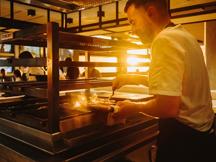 Cocinero en las brasas del restaurante Muka