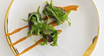 Yuca asada en caldo de frijoles con crema de mamey y achiote